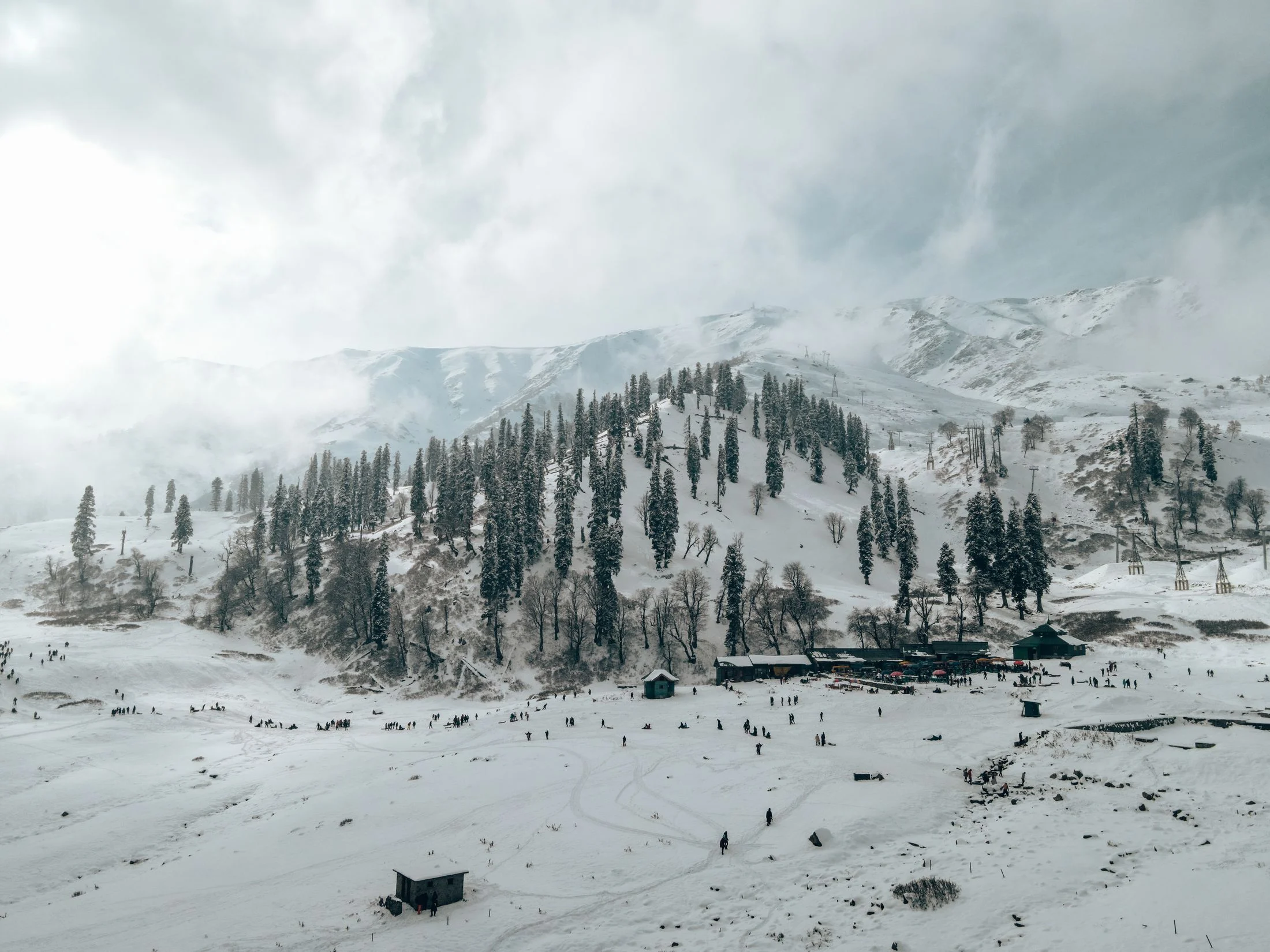 The snow-covered Gulmarg bowl with pine-clad slopes and ski runs