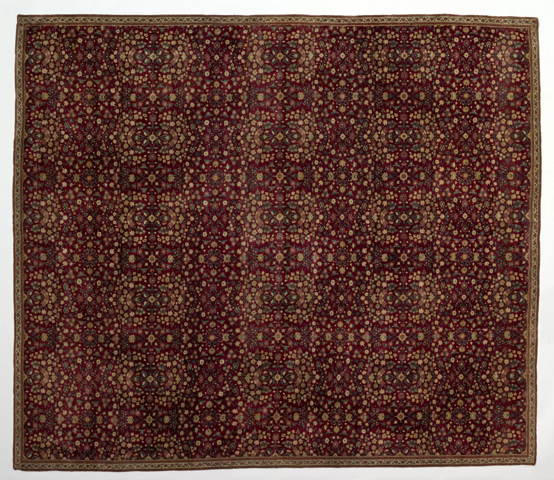 A hand-knotted Kashmir wool carpet with a dense floral pattern