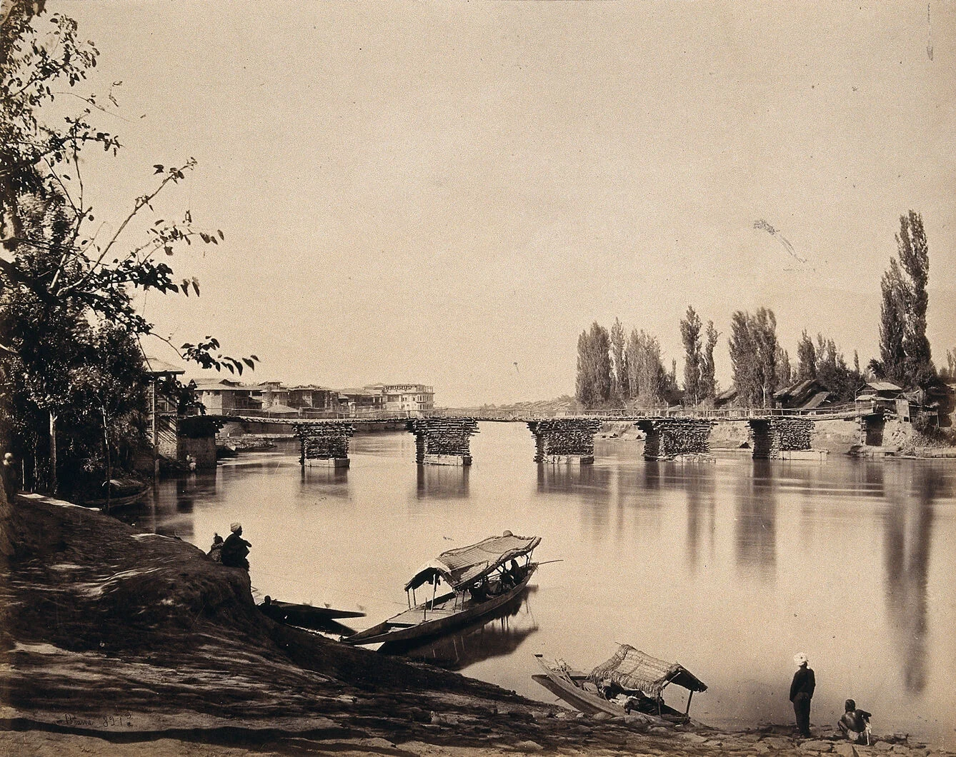 A bridge over the Jhelum in Srinagar with boats below