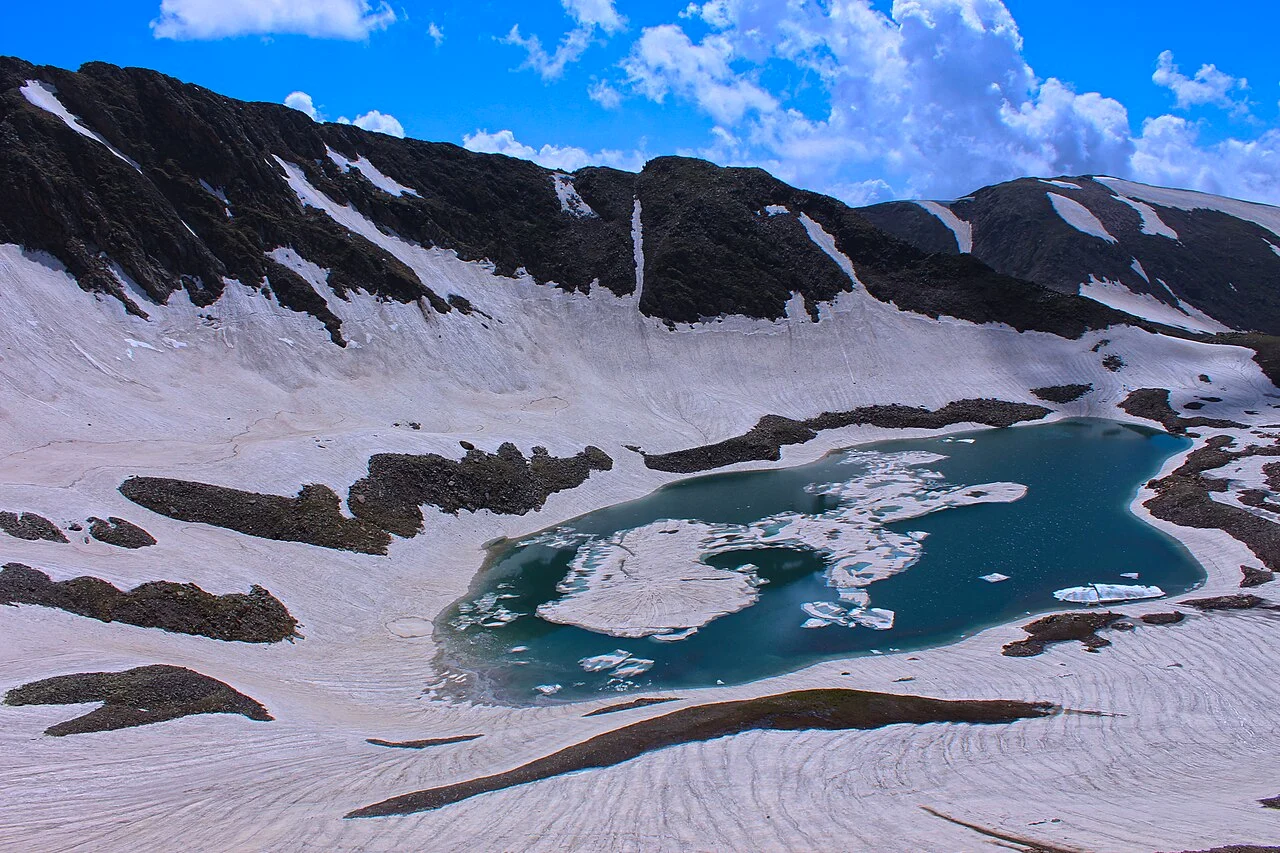 Alpather Lake half frozen below snowy ridges