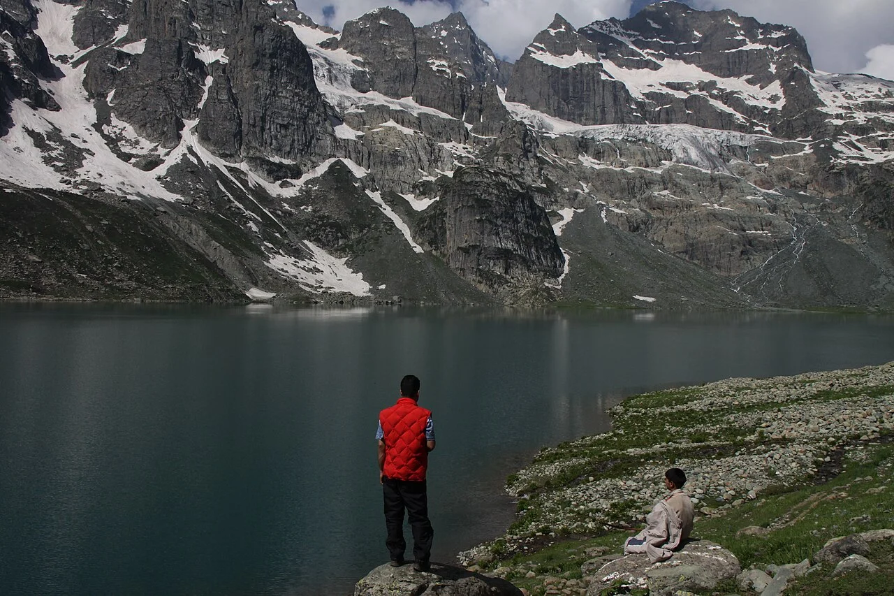 A walker at Gangbal Lake below the Harmukh massif