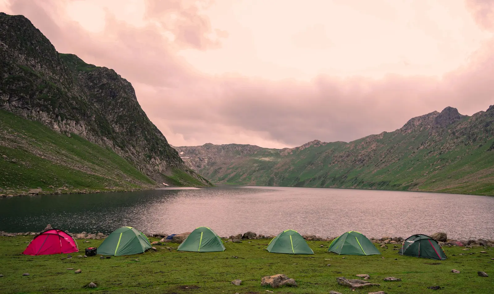 Tents pitched beside a high alpine lake