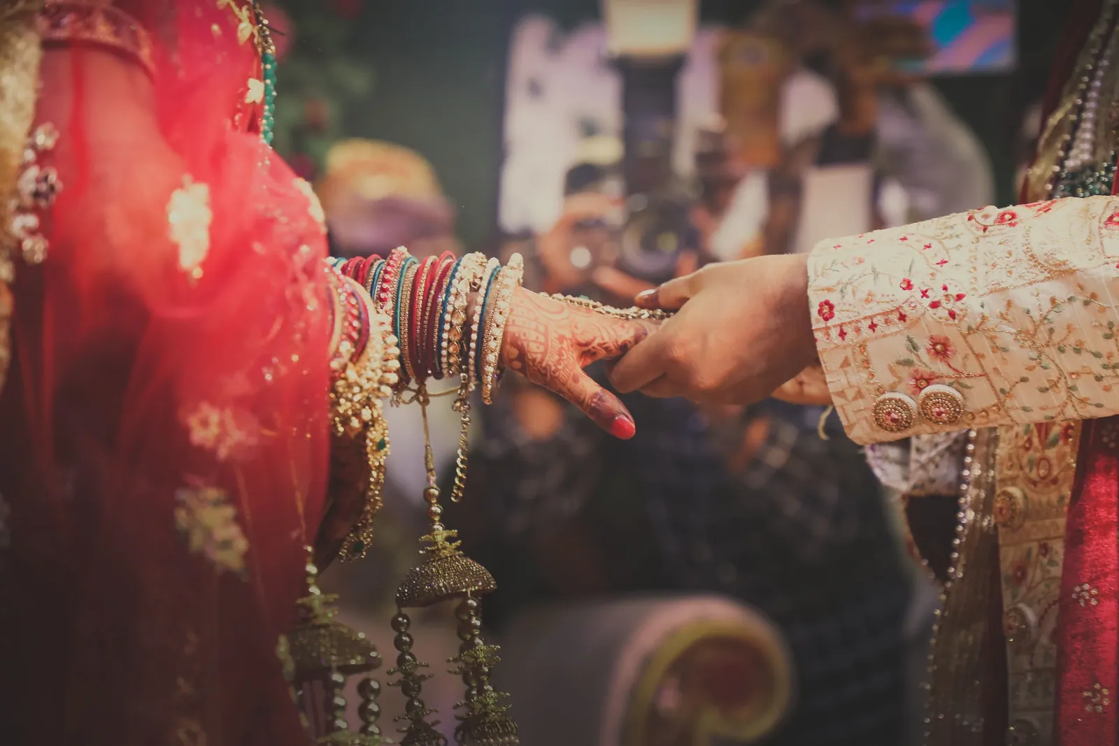 A bride and groom hold hands during a wedding ceremony
